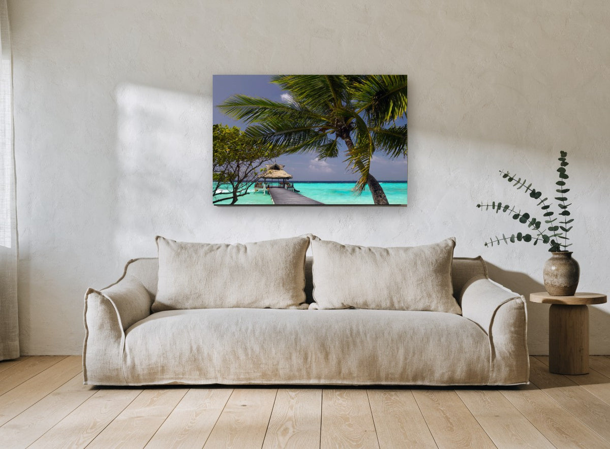 Palm Over the Jetty coastal canvas print on the wall of a living room