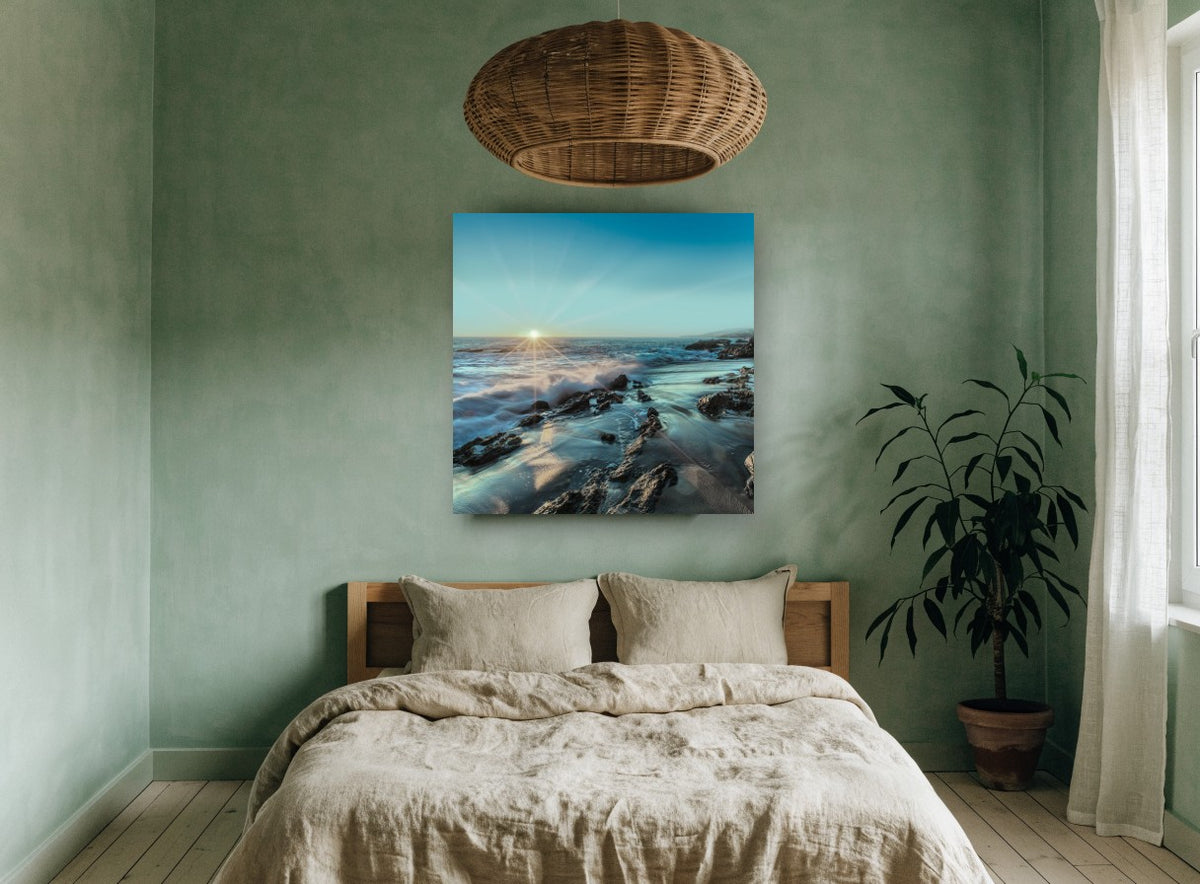 Starburst Over Rocky Shore coastal canvas print on the wall of a bedroom