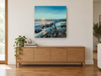 Starburst Over Rocky Shore coastal canvas print on the wall of a living room above a sideboard