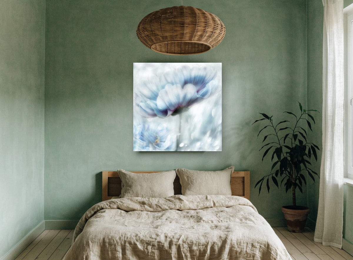 Pale Blue Bloom Haze floral canvas print on the wall of a bedroom