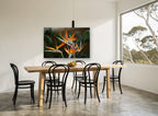 Orange Crane Blooms floral canvas print on the wall of a dining room