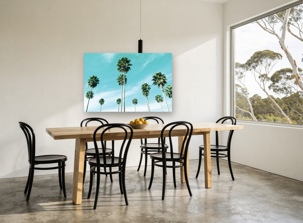 Palms Against Turquoise coastal canvas print on the wall of a dining room