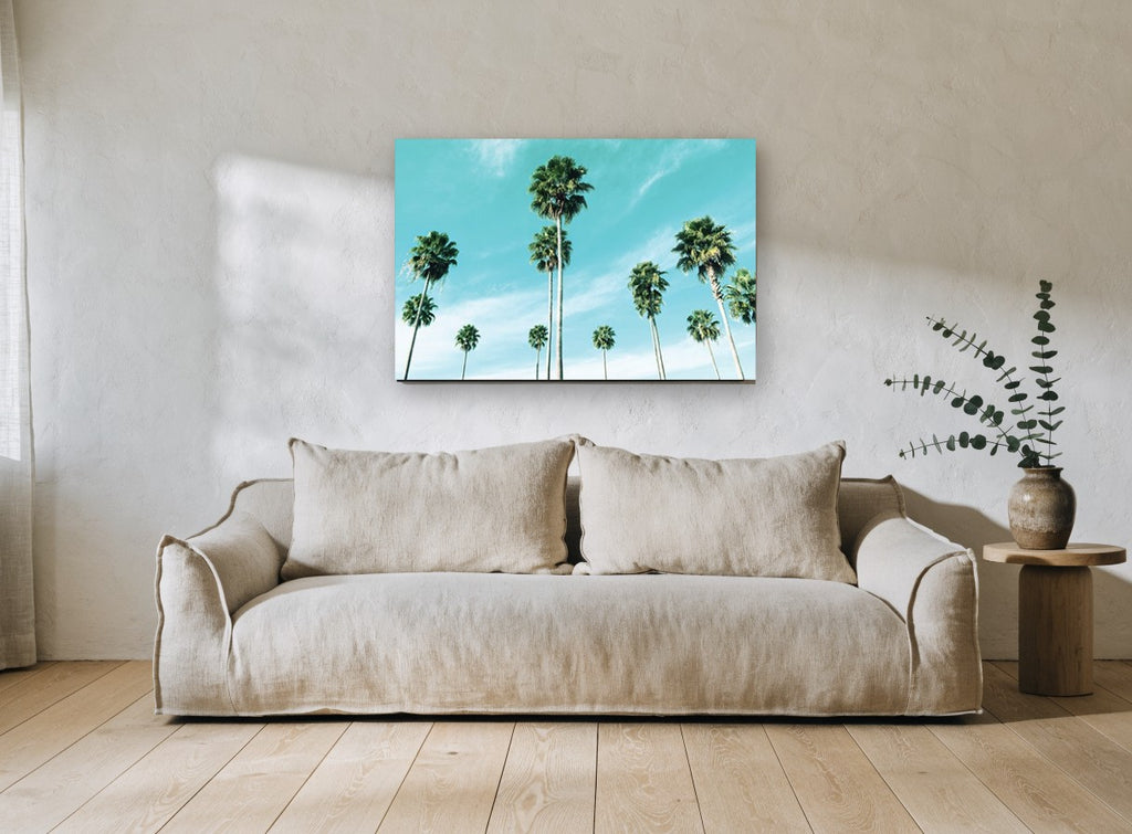 Palms Against Turquoise coastal canvas print on the wall of a living room