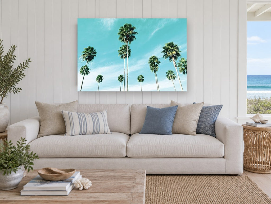 Palms Against Turquoise coastal canvas print on the wall of a beach house living room
