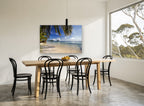 Palm Shade Shallows coastal canvas print on the wall of a dining room