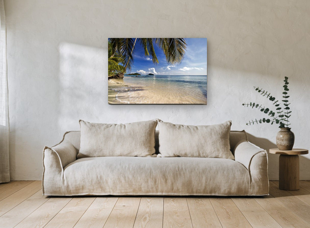 Palm Shade Shallows coastal canvas print on the wall of a living room