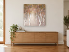 Blush Birch Glow landscape canvas print on the wall of a living room above a sideboard