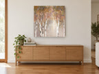 Mauve Mist Birches landscape canvas print on the wall of a living room above a sideboard