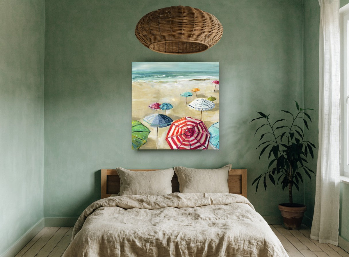 Striped Umbrellas on Sand coastal canvas print on the wall of a bedroom