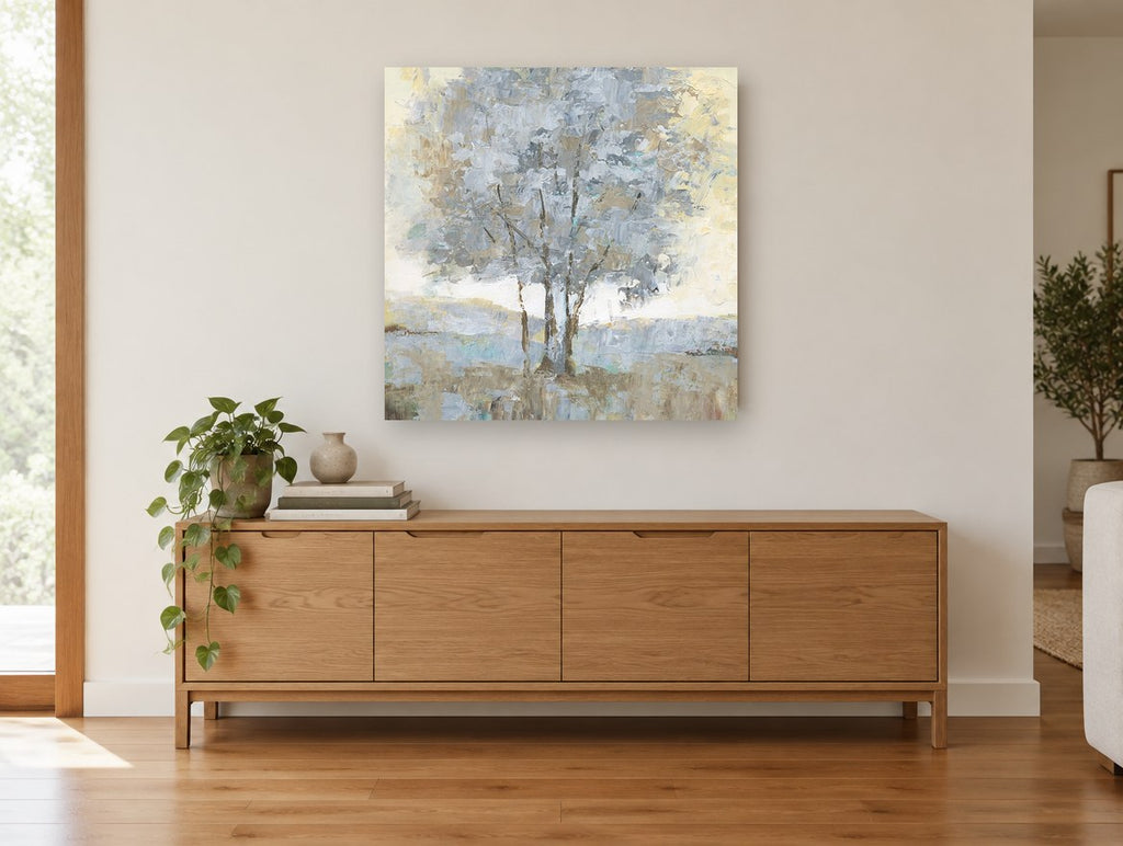 Silver Birch Haze landscape canvas print on the wall of a living room above a sideboard