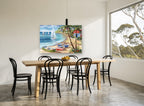 Rowboats and Palms Cove coastal canvas print on the wall of a dining room