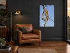 Leopard Up The Branch animal canvas print on the wall of a charcoal living room