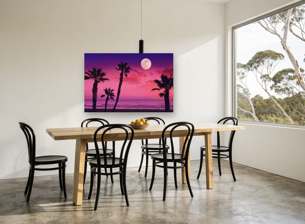 Pink Moonrise Palms coastal canvas print on the wall of a dining room