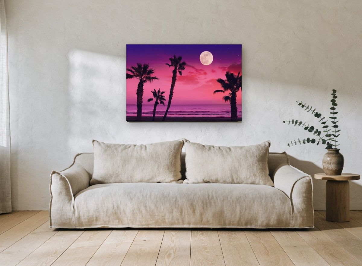Pink Moonrise Palms coastal canvas print on the wall of a living room