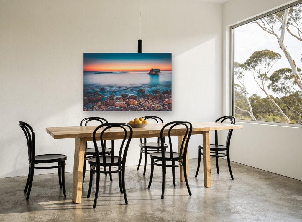 Pebble Shore Afterglow coastal canvas print on the wall of a dining room