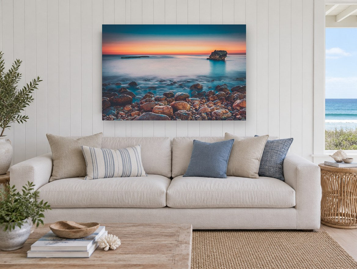 Pebble Shore Afterglow coastal canvas print on the wall of a beach house living room