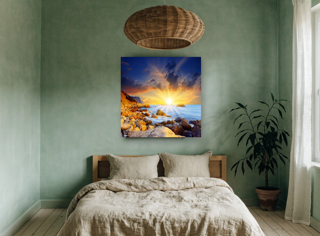 Sunburst Over Rocky Shore coastal canvas print on the wall of a bedroom