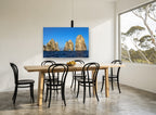 Three Sunlit Sea Stacks coastal canvas print on the wall of a dining room