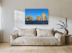 Three Sunlit Sea Stacks coastal canvas print on the wall of a living room
