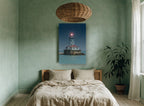 Glowing Harbour Light coastal canvas print on the wall of a bedroom