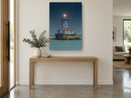 Glowing Harbour Light coastal canvas print on the wall of a entry hall