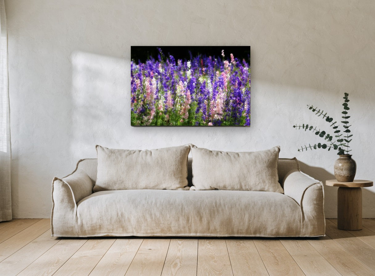 Larkspur Meadow Glow floral canvas print on the wall of a living room