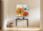 Translucent Orange Bloom Trio floral canvas print on the wall of a hallway