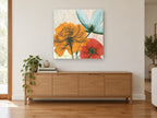Translucent Orange Bloom Trio floral canvas print on the wall of a living room above a sideboard