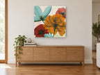 Translucent Bloom Quartet floral canvas print on the wall of a living room above a sideboard