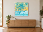 Teal Tree at Dusk floral canvas print on the wall of a living room above a sideboard