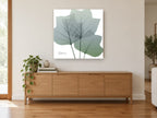 Translucent Tulip Leaves floral canvas print on the wall of a living room above a sideboard