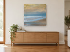 Golden Dusk Shoreline coastal canvas print on the wall of a living room above a sideboard