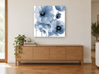 Indigo Poppy Wash floral canvas print on the wall of a living room above a sideboard