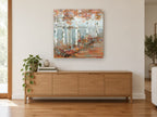 Birch Lake Walk landscape canvas print on the wall of a living room above a sideboard