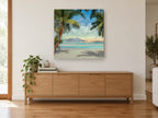 Palm Shade Cove coastal canvas print on the wall of a living room above a sideboard