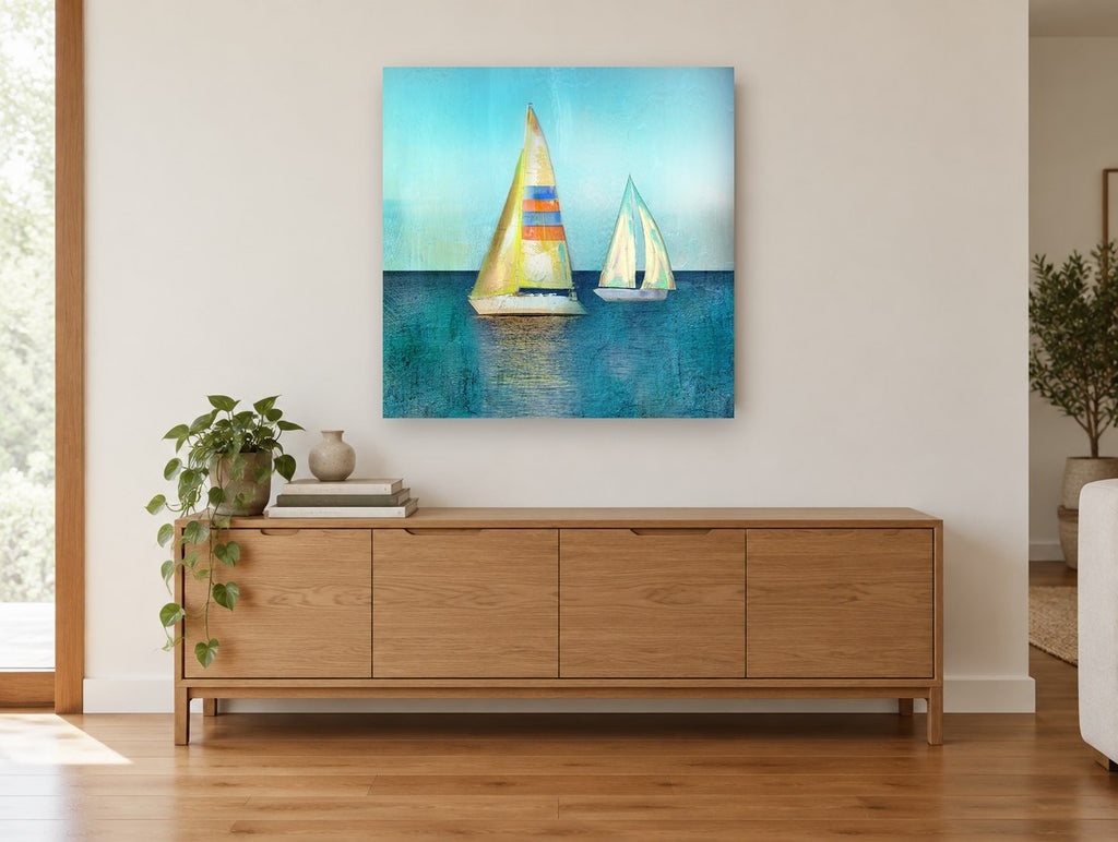 Two Sails Teal Calm coastal canvas print on the wall of a living room above a sideboard