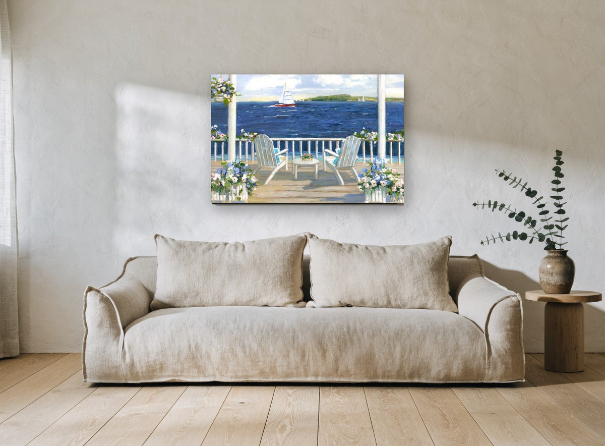 Porch Chairs and Sail coastal canvas print on the wall of a living room