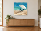 Shaded Chairs by the Shore coastal canvas print on the wall of a living room above a sideboard