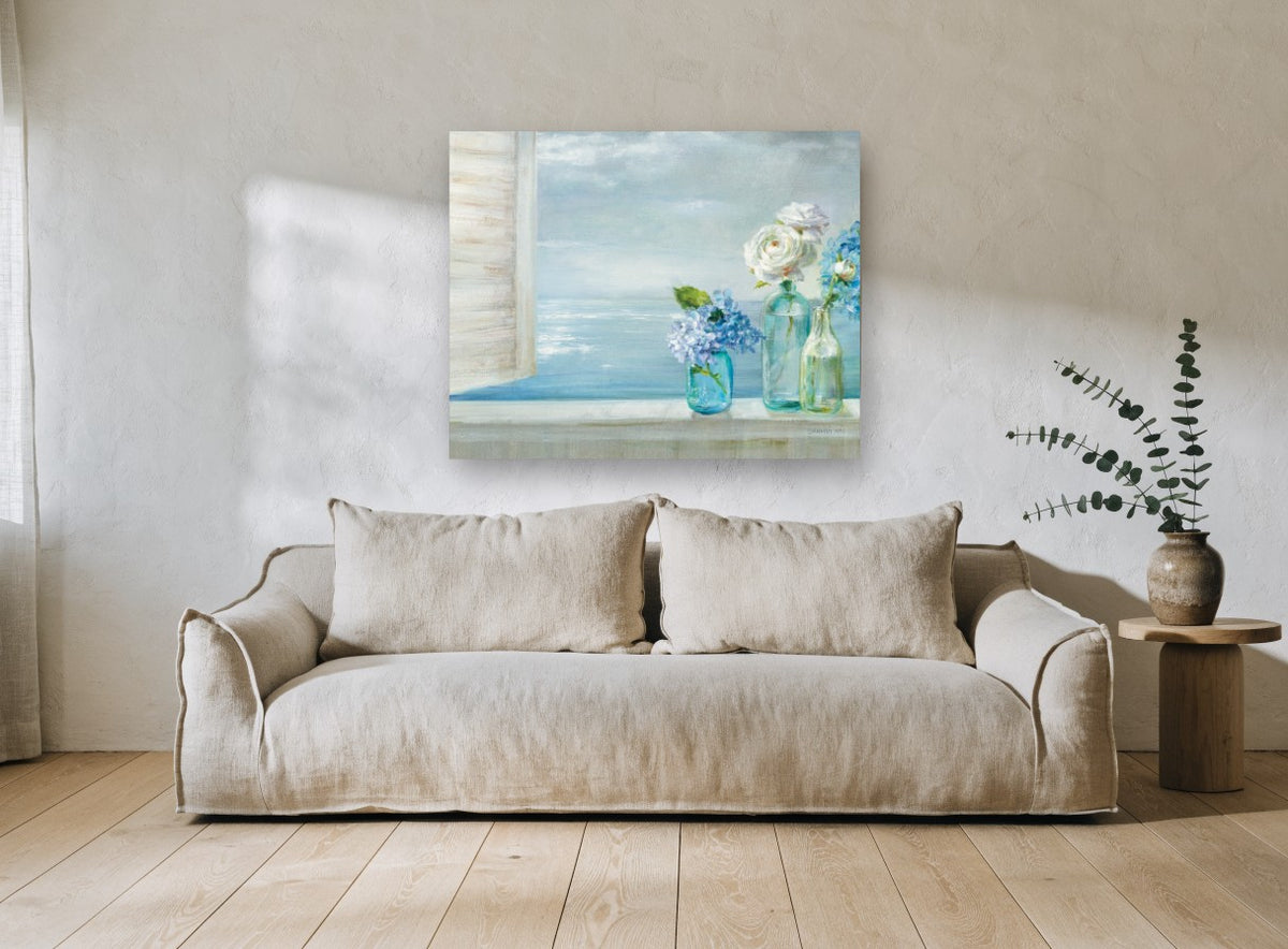 Windowsill Hydrangeas by the Sea coastal canvas print on the wall of a living room