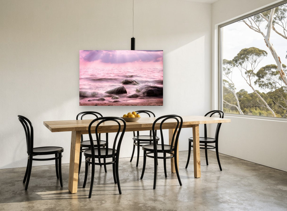 Pink Tide Boulders coastal canvas print on the wall of a dining room