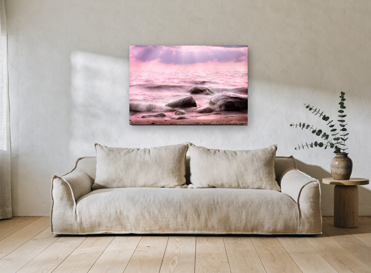 Pink Tide Boulders coastal canvas print on the wall of a living room