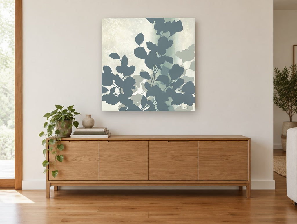 Slate Leaf Silhouettes floral canvas print on the wall of a living room above a sideboard