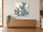 Slate Leaf Silhouettes floral canvas print on the wall of a living room above a sideboard