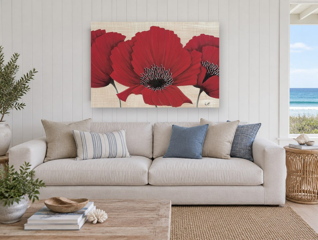 Three Red Poppies floral canvas print on the wall of a beach house living room