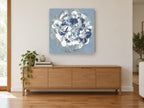 Blue Hydrangea Swirl floral canvas print on the wall of a living room above a sideboard