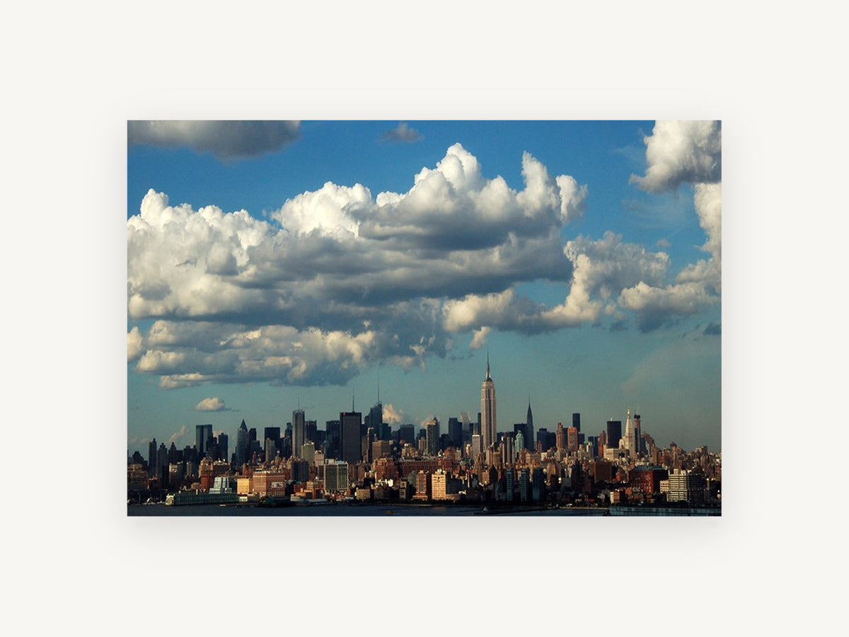 Manhattan Under Cumulus, new york skyline under big clouds, city canvas wall art print, front view