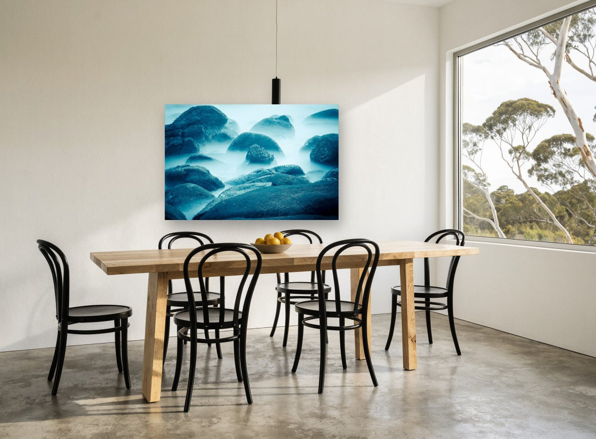 Blue Mist Boulders coastal canvas print on the wall of a dining room