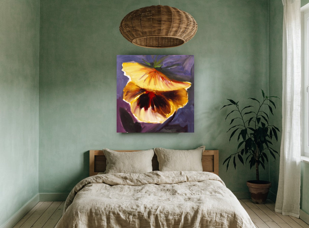 Golden Pansy Glow floral canvas print on the wall of a bedroom