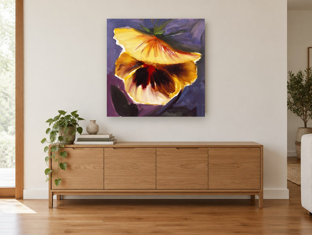 Golden Pansy Glow floral canvas print on the wall of a living room above a sideboard