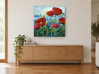 Poppies Against Blue Sky floral canvas print on the wall of a living room above a sideboard